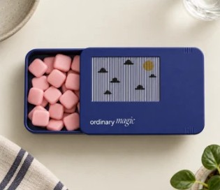 The tin slid open, full of soft pink square chews.